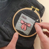 Réalisation du kit de broderie Noeud rose de Fukuri sur un jean noir